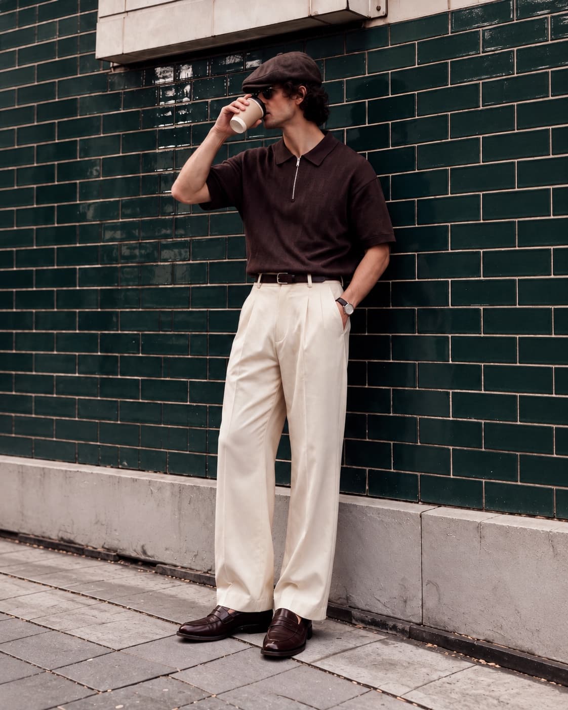 The polo worn on the street with cream pleated trousers